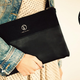 Image for article titled A Sturdy Black Clutch That Holds Almost Anything